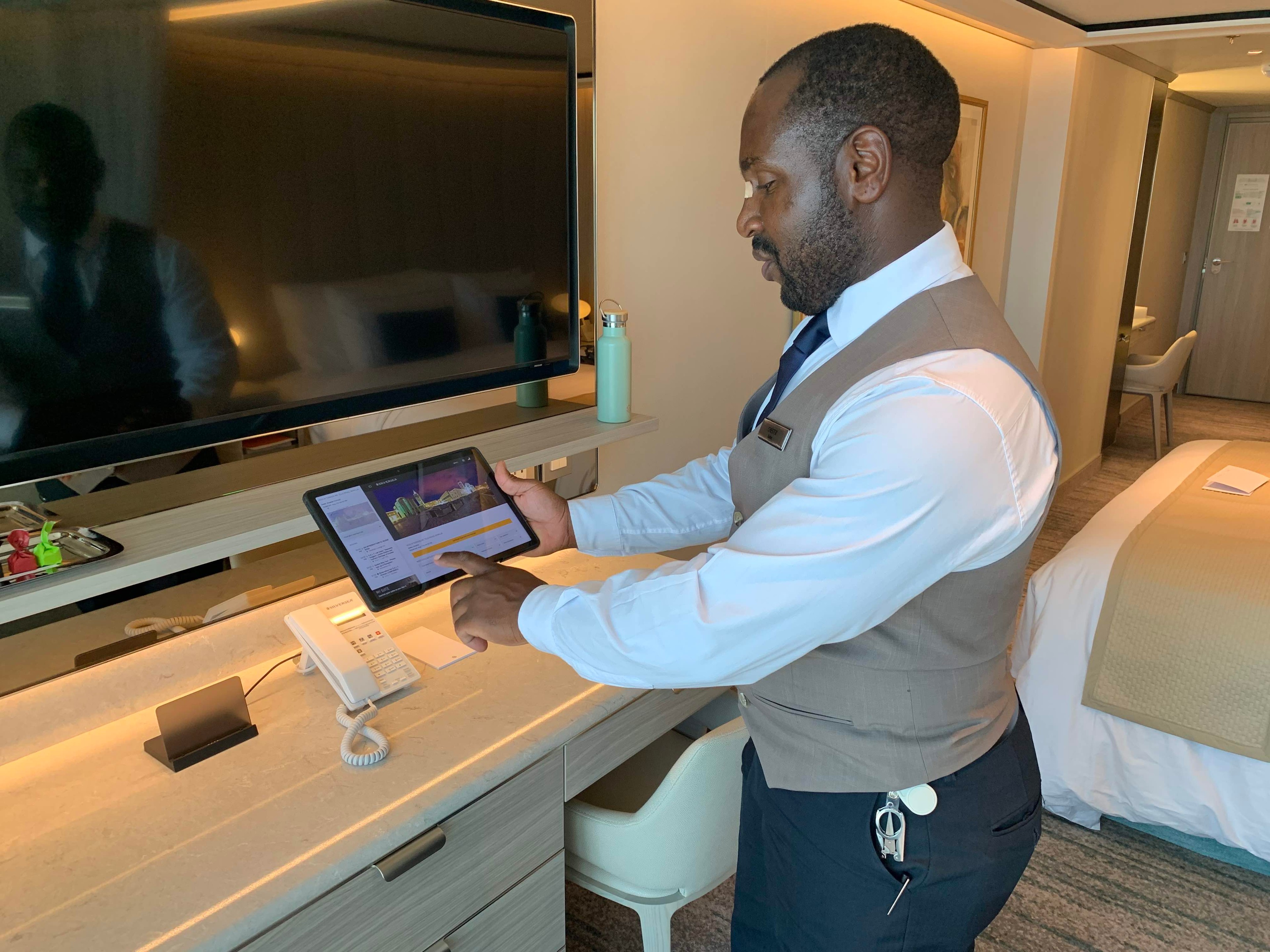 Chester, my butler, shows me how to work the Lenovo pad on Silver Nova. /Photo by Teijo Niemela for Silversea