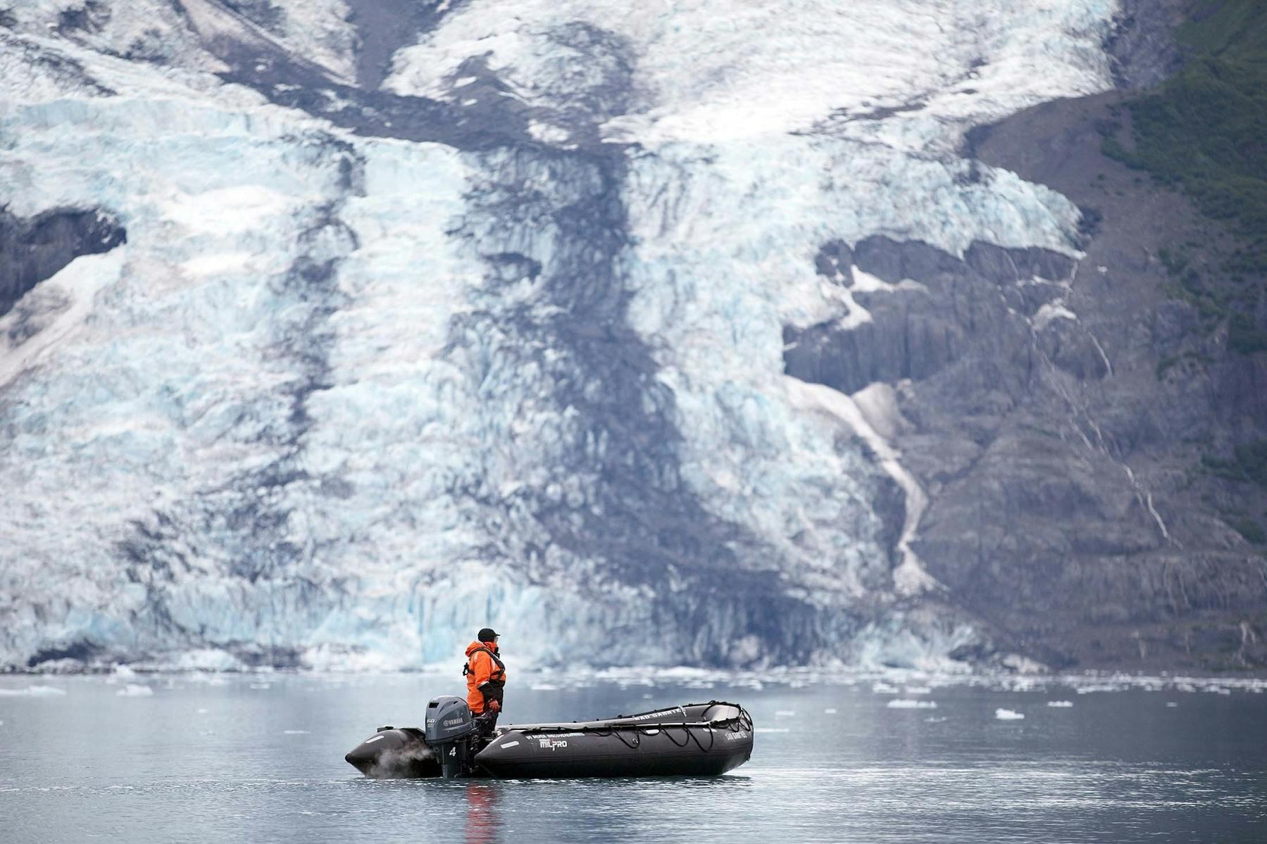 A member of Silversea's Expedition Team operates a Zodiac near the Harvard Glacier at Prince William Sound, Alaska./Lucia Griggi