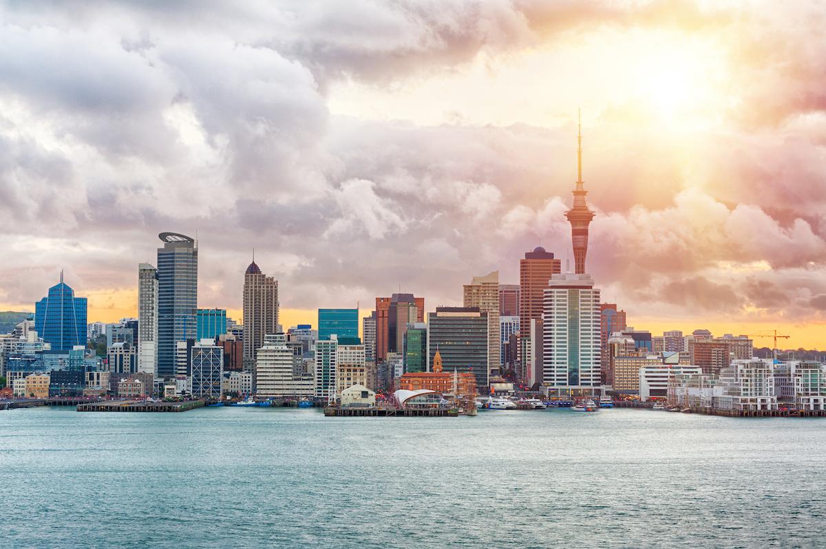 Skyline photo of the biggest city in the New Zealand, Auckland. The photo was taken during the golden sunset across the bay/Shutterstock