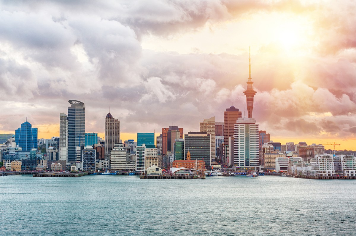 Skyline photo of the biggest city in the New Zealand, Auckland. The photo was taken during the golden sunset across the bay/Shutterstock