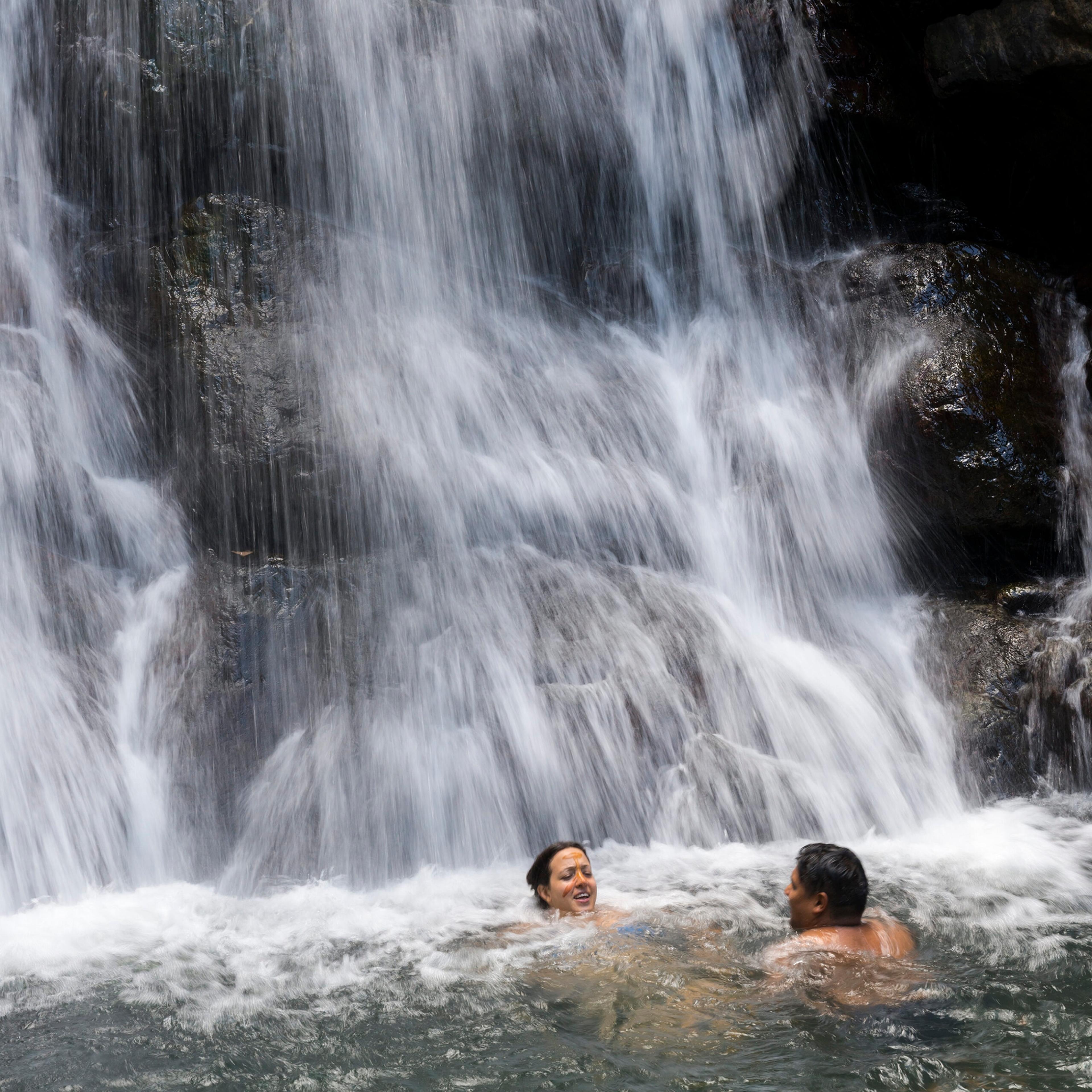 Swimmers at La Mina Falls at El Yunque National Forest in Puerto Rico/Getty Images
