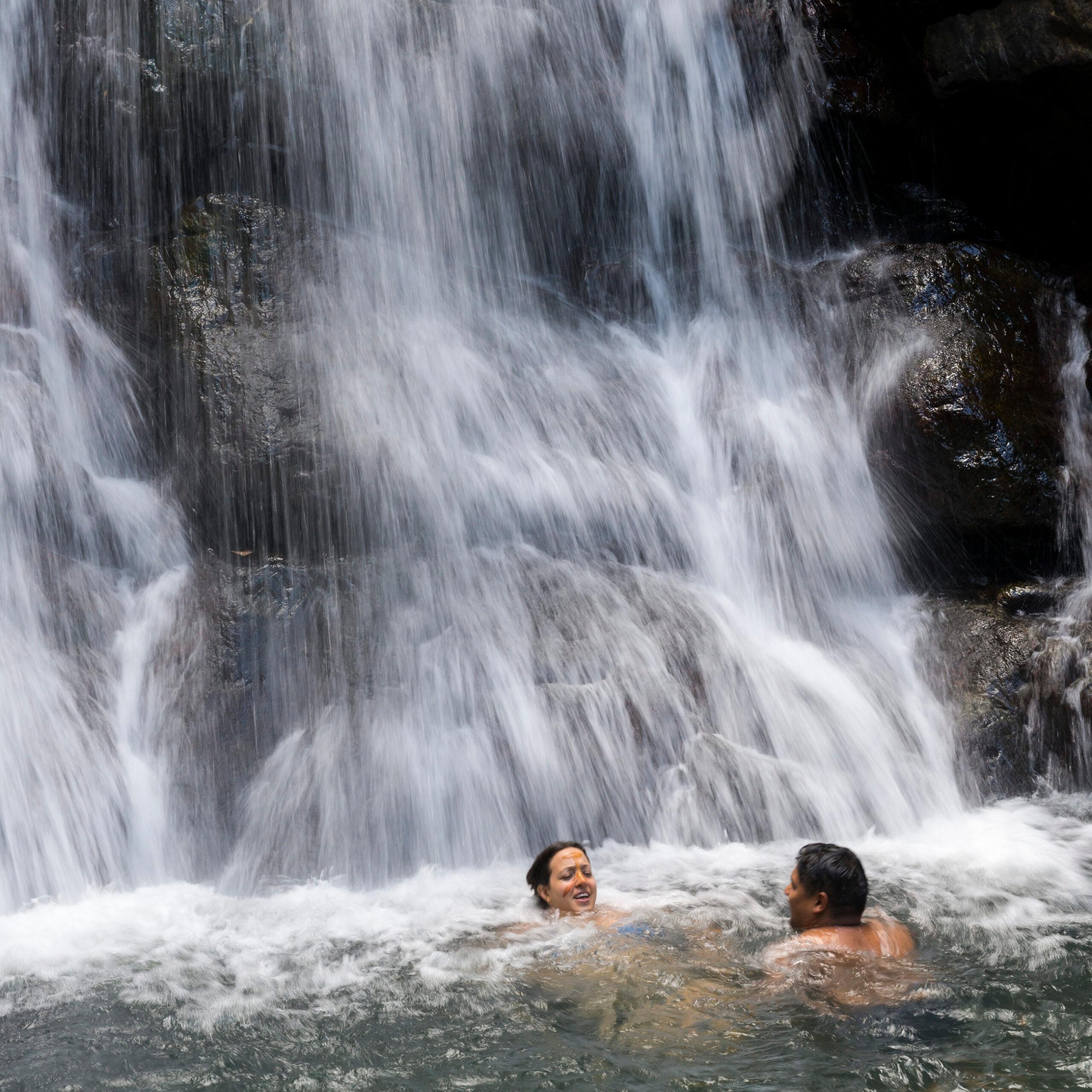 Swimmers at La Mina Falls at El Yunque National Forest in Puerto Rico/Getty Images