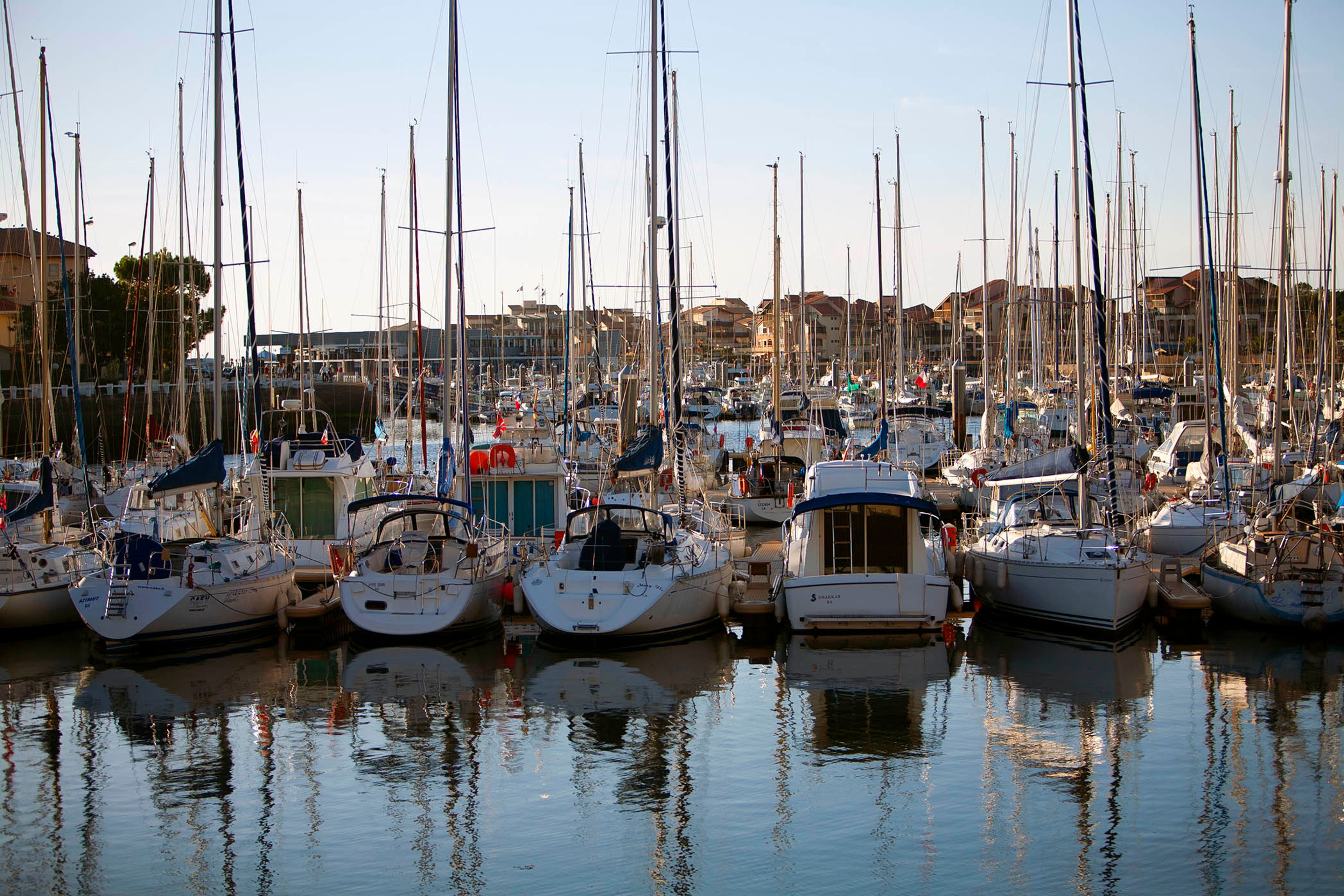 Sailboats bobbing against a backdrop of pastel-colored houses in the French Riviera./ Silversea photo