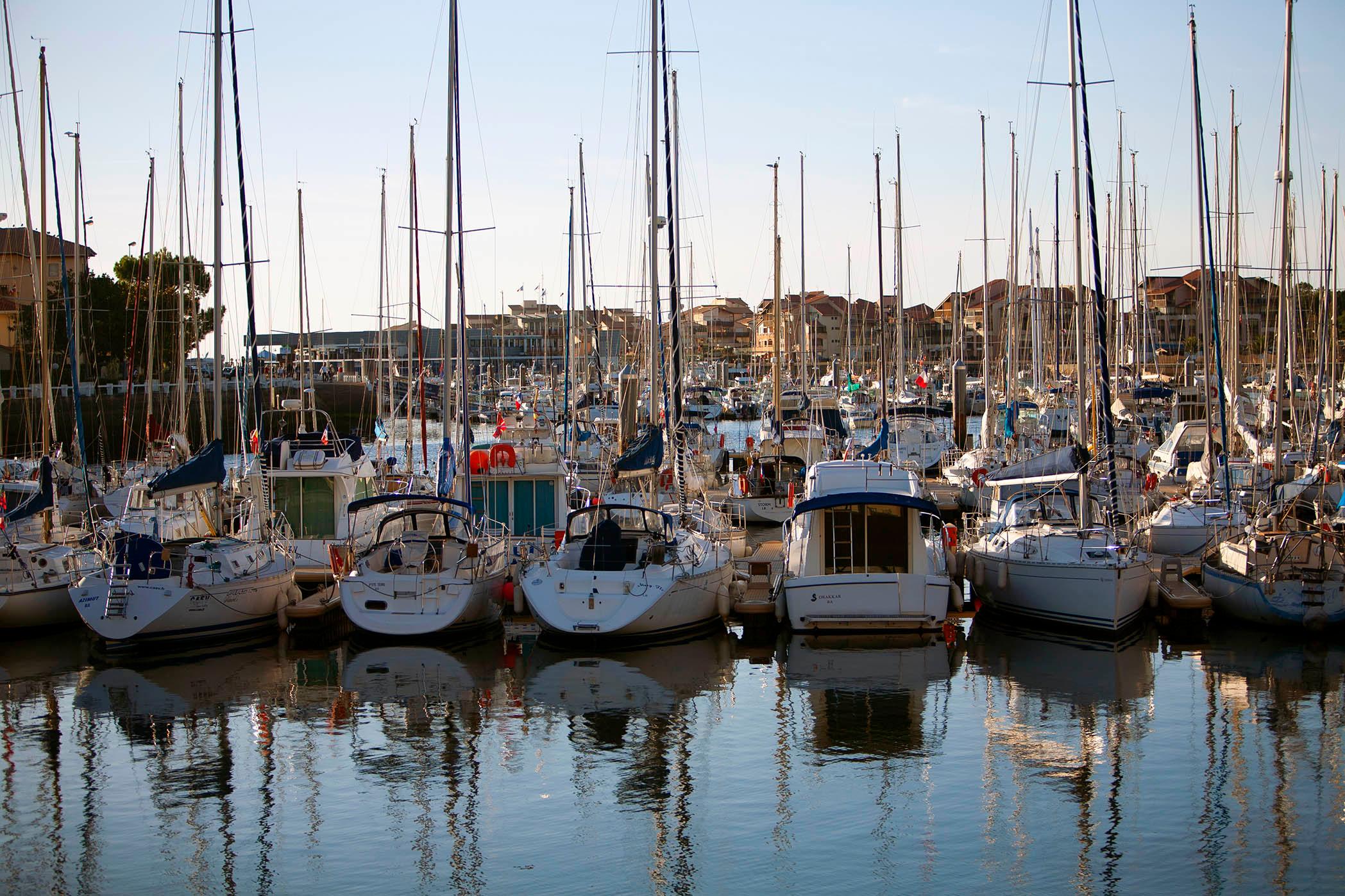 Sailboats bobbing against a backdrop of pastel-colored houses in the French Riviera./ Silversea photo