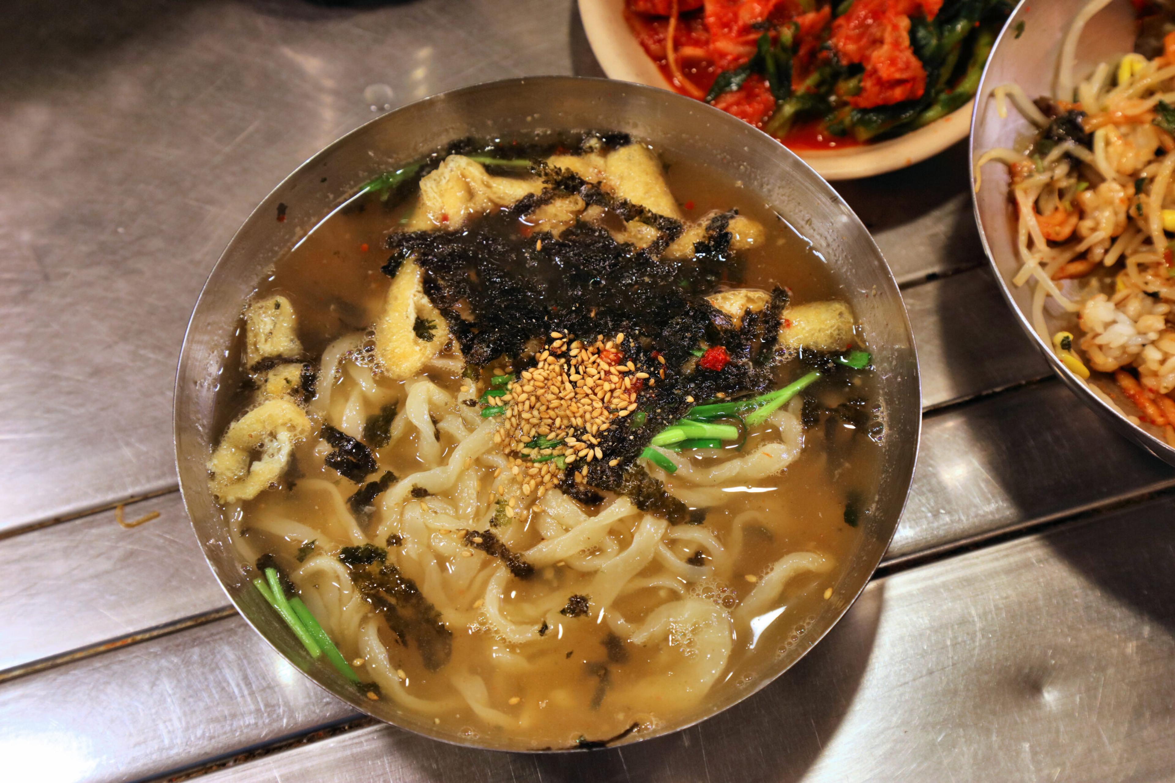 Famous knife-cut noodles, called kalguksu, in Namdaemun Market, Seoul/Getty Images