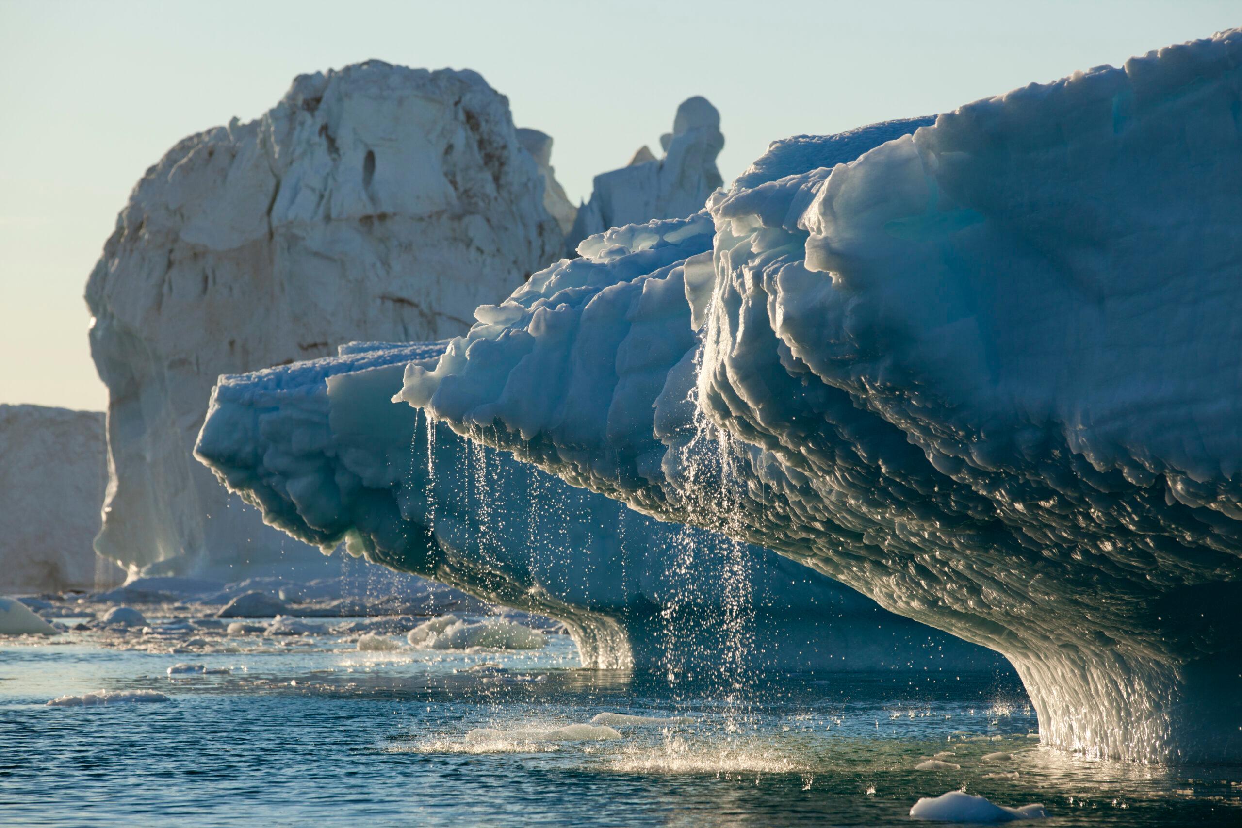 Massive icebergs from Jakobshavn Glacier melting in Disko Bay on a sunny summer evening in Ilulissat, Greenland/Getty Images