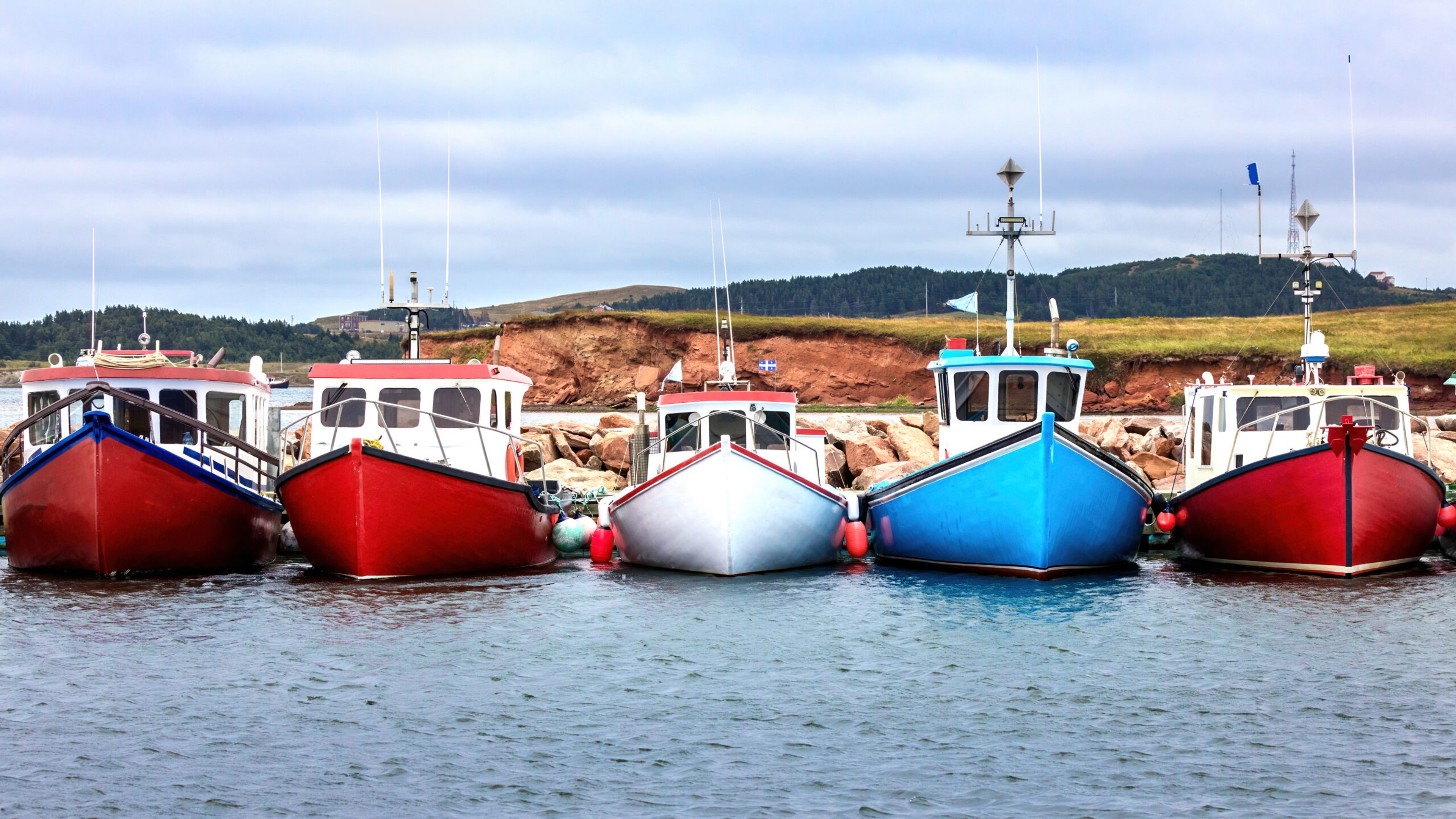 A row of colorful fishing boats in the harbor of Havre Aubert, Magdalen Islands, Canada./iStock photos