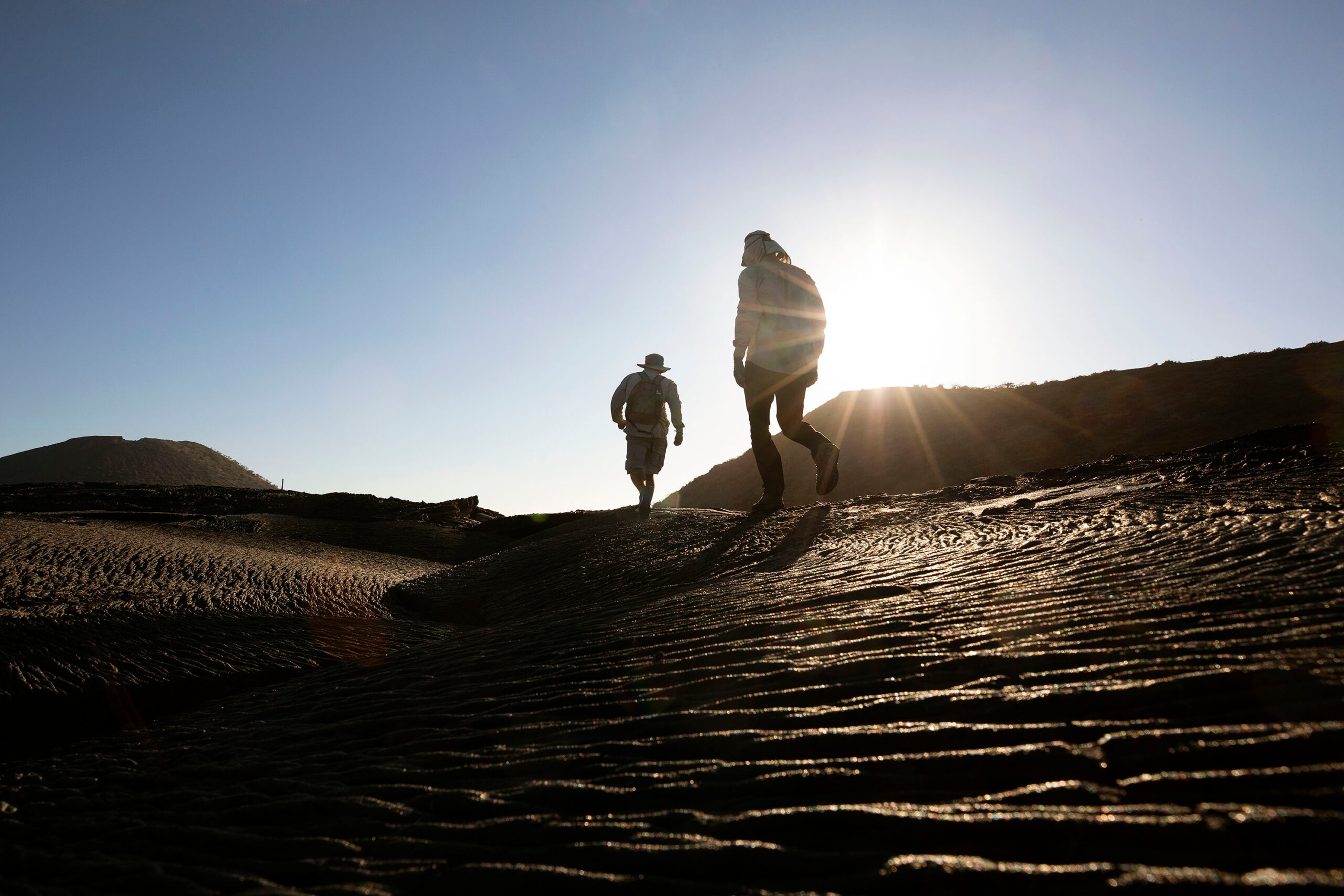Silversea expedition staff walking on the lava fields./Lucia Griggi