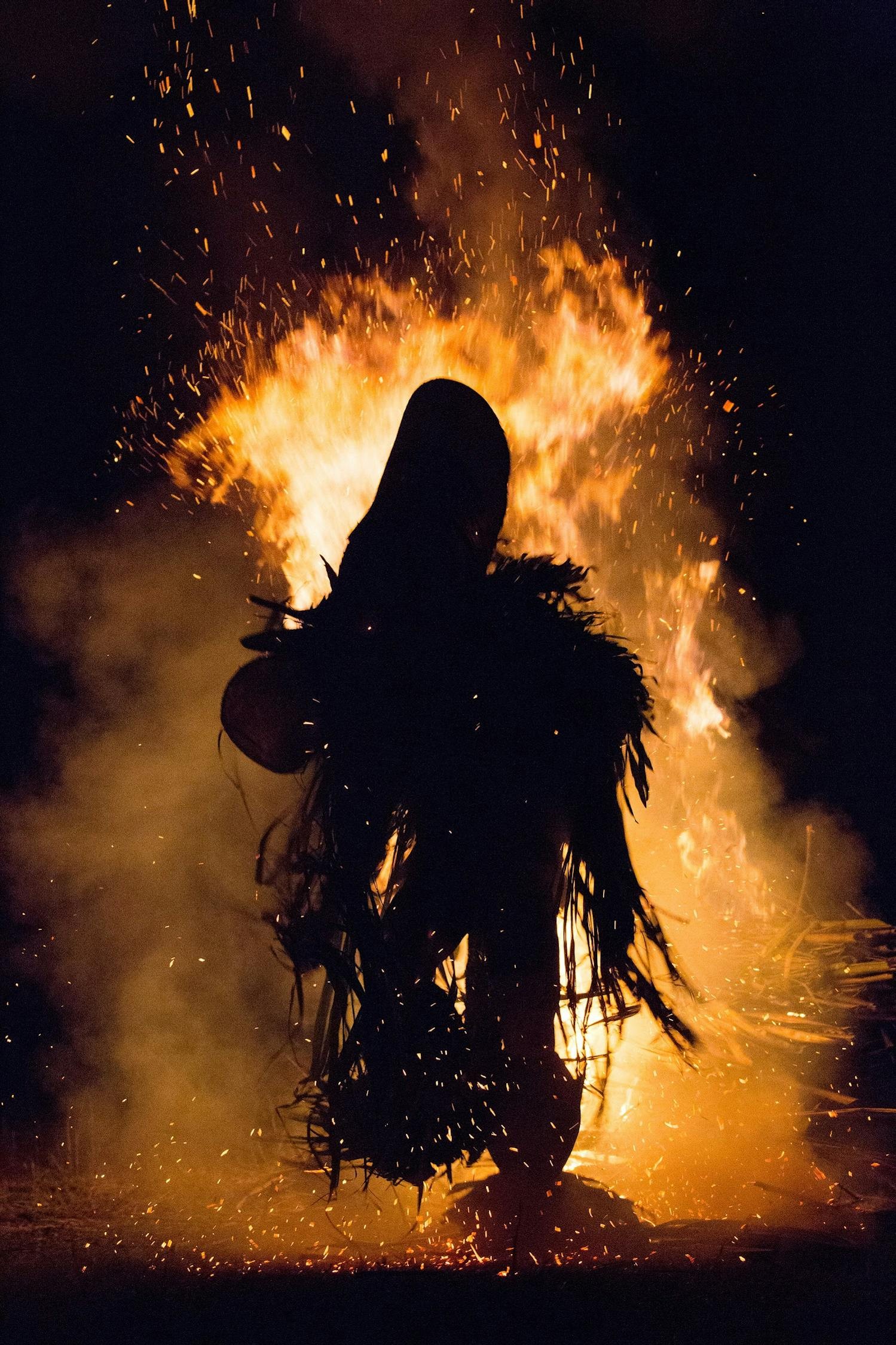 The silhouette of a Baining Fire Dancer in traditional attire/Denis Elterman