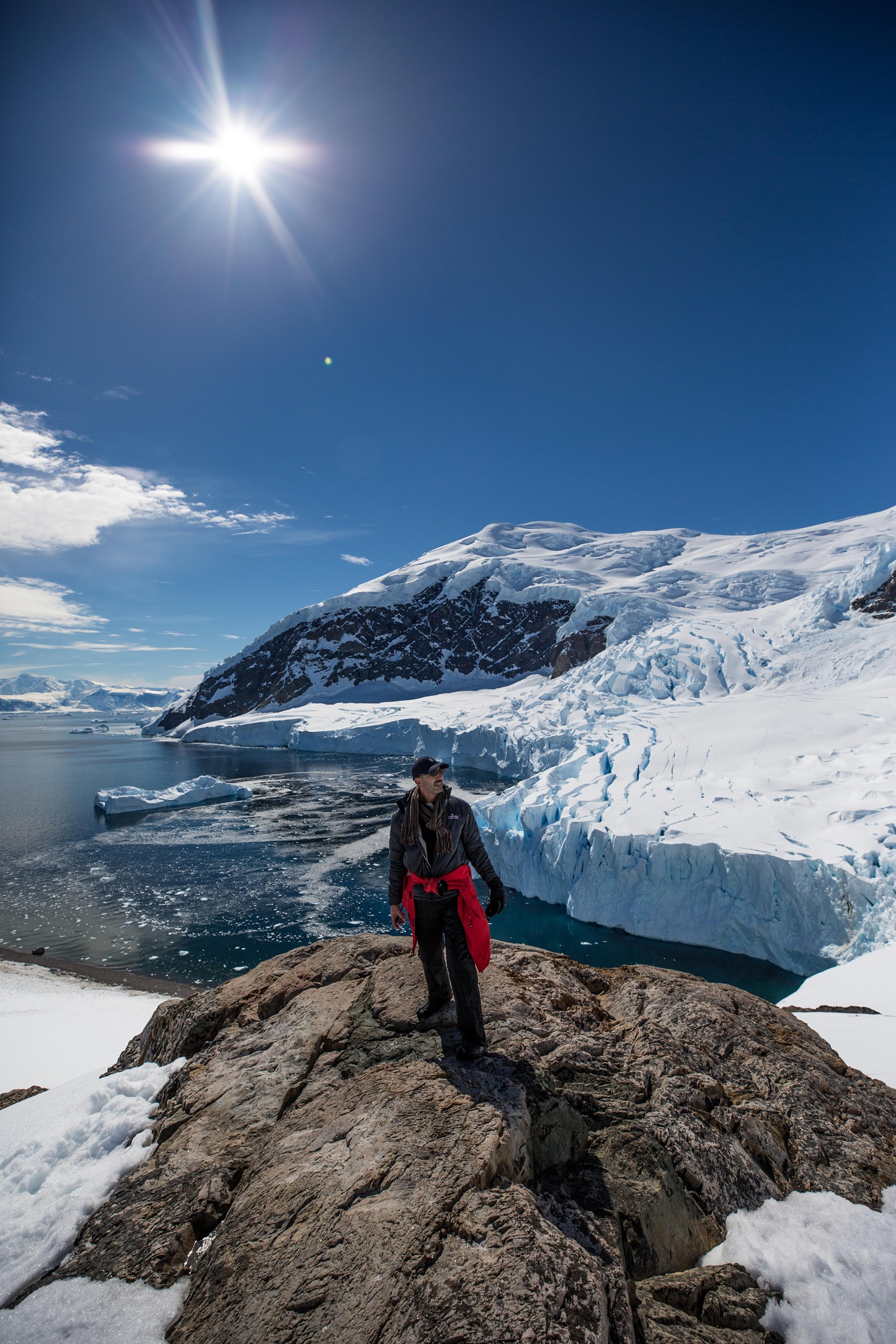 One of Silversea's guests stands atop a rock in Neko Harbour/Ross Vernon McDonald