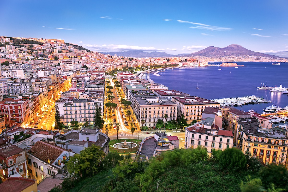 The city of Naples with the imposing sight of Mount Vesuvius in the distance/Shutterstock