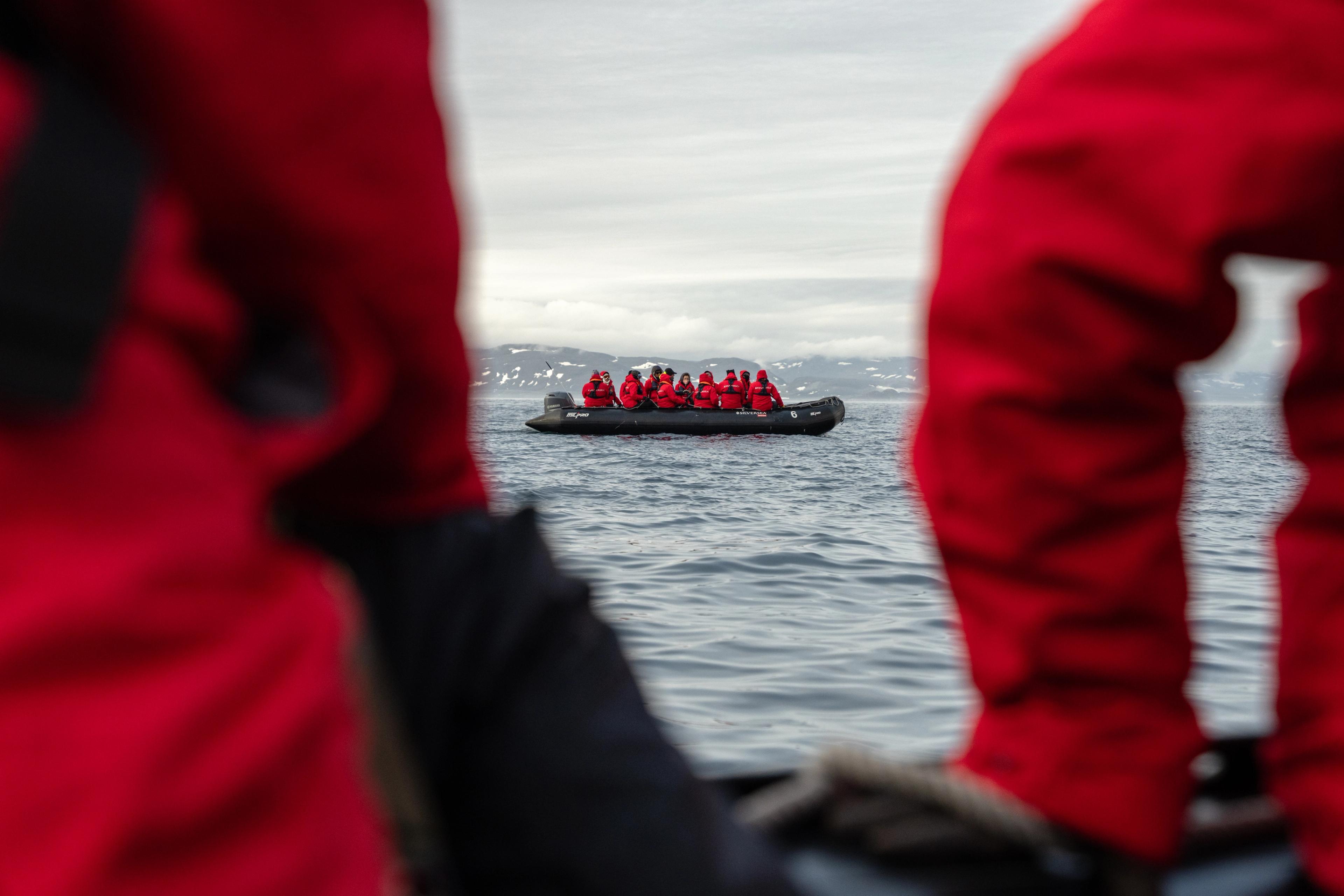 A group of explorers are transported to glacier viewing from a cruise ship with Zodiac.