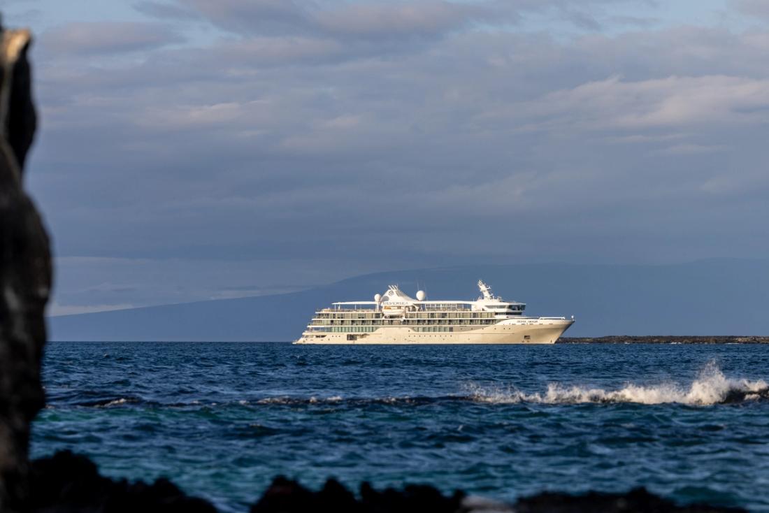 Silver Origin at anchor off a rocky Galápagos shore