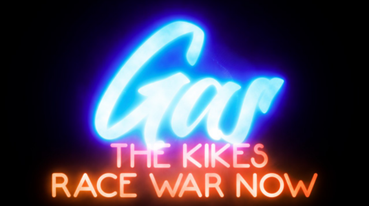 Neon sign-styled text on a black background. "Gas THE KIKES RACE WAR NOW"