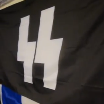 A black flag with two white Sowilo runes in the centre, resembling "SS".