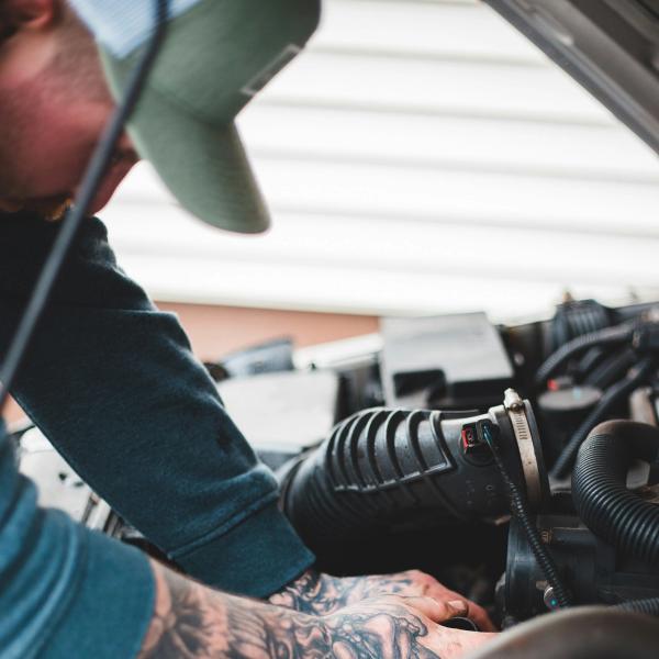 A mechanic working under the hood of a car. picture.