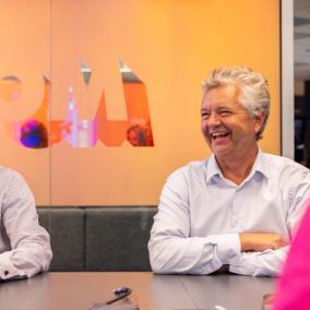 Two employees in a Morrow Bank meeting room