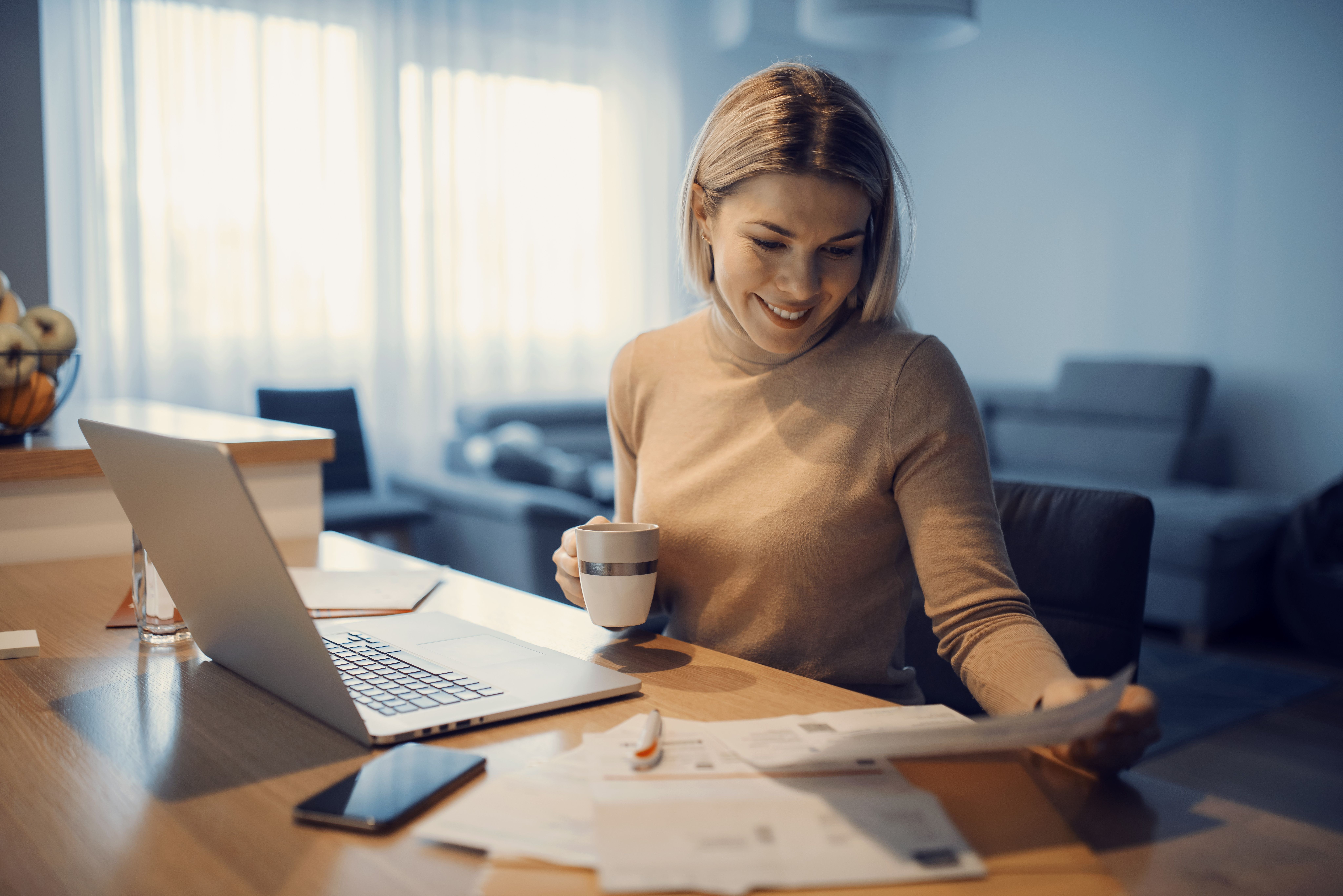 A woman sitting by the computer, trying to get her finances in order. picture.