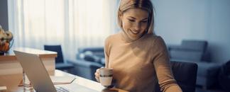 A woman sitting by the computer, trying to get her finances in order. picture.