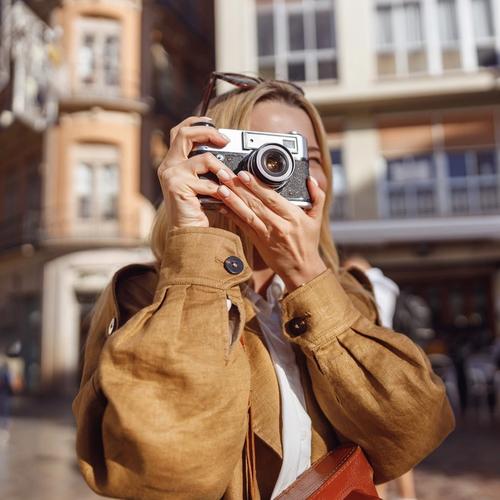 Woman with travel insurance through Morrow Bank is taking pictures when traveling. picture.