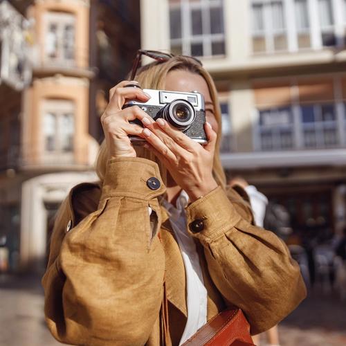 Woman with travel insurance through Morrow Bank is taking pictures when traveling. picture.