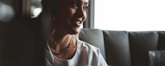 A woman talking around a dinner table.
