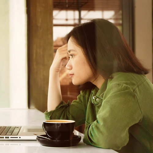 A girl looking at her laptop, reading information on her ID theft protection service. picture.