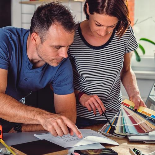 Man and woman are looking at color options for kitchen renovation. picture.