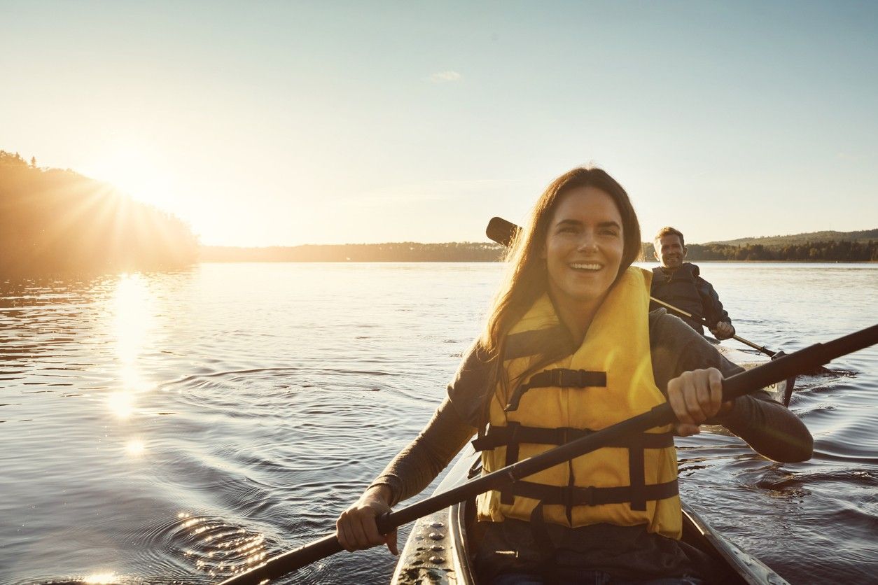 A woman and a man kayaking on a lake. picture.