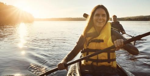 A woman and a man kayaking on a lake. picture.