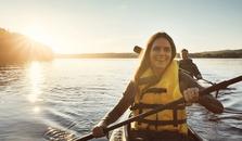 A woman and a man kayaking on a lake. picture.