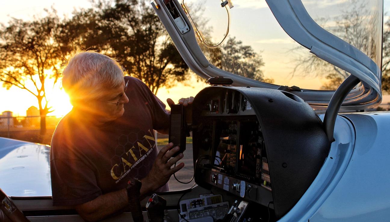 A man is working on a small airplane.