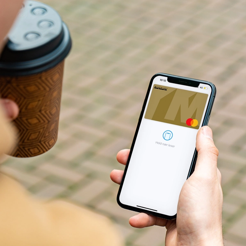 A man has paid his coffee with Morrow Bank credit card in digital wallet. picture.