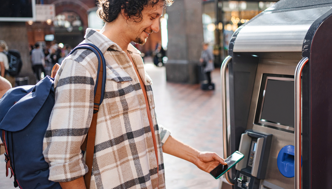 A man buying a train ticket with Google Pay. picture.