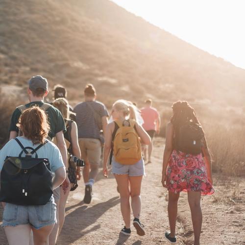 A group of people hiking in the sunrise