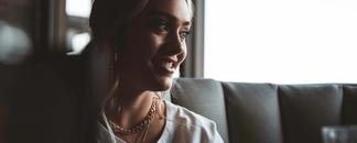 A woman talking around a dinner table.