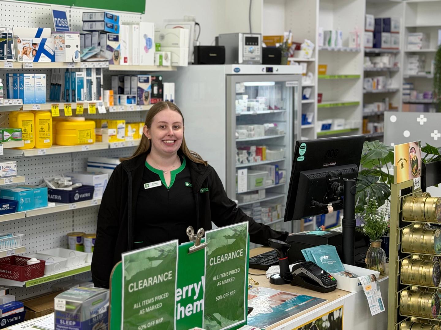 Staff member at the counter of Amcal Express Marden Chemist in South Australia.