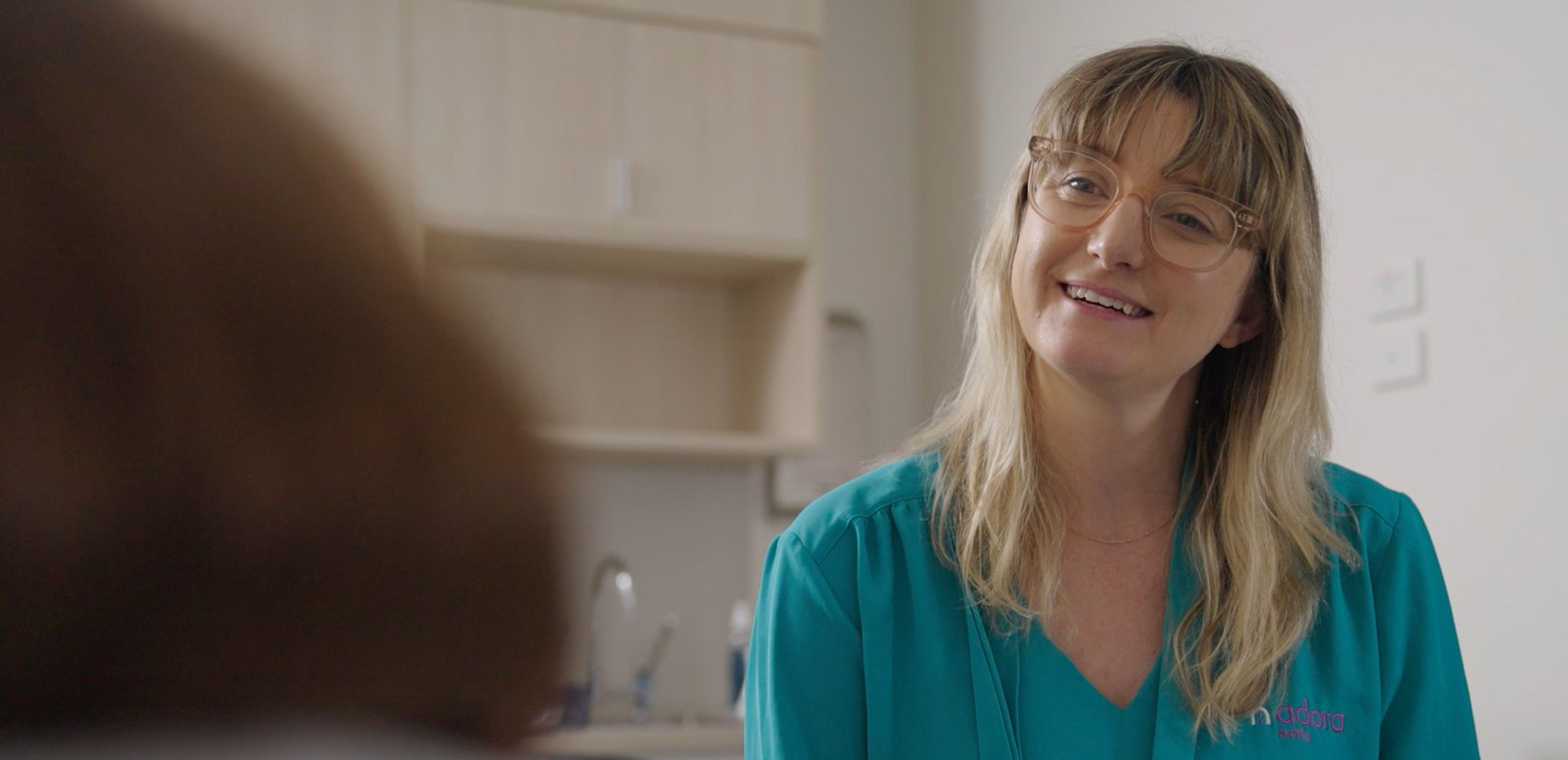 A nurse speaks to a patient 