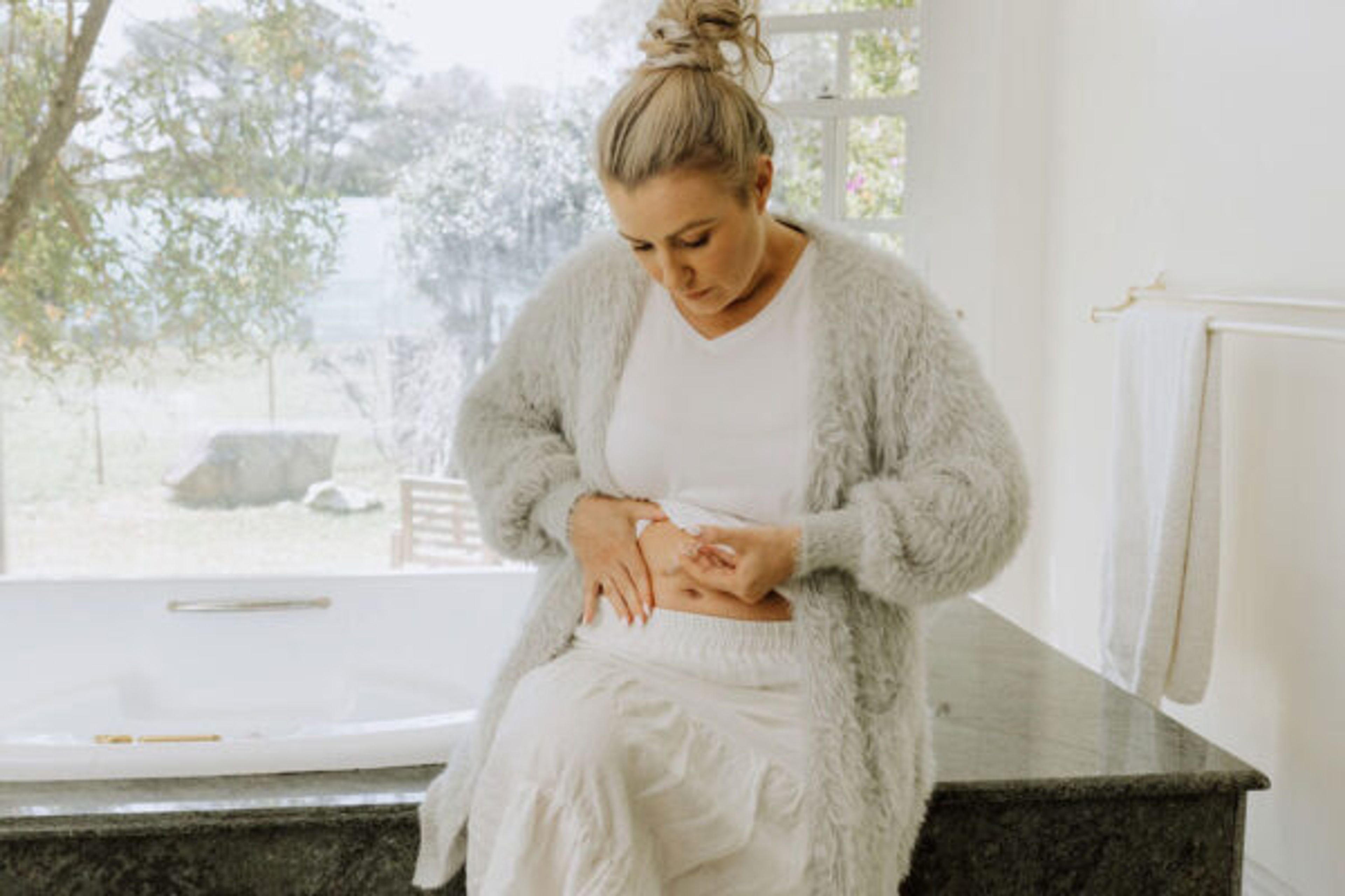 Woman giving herself an injection in the stomach