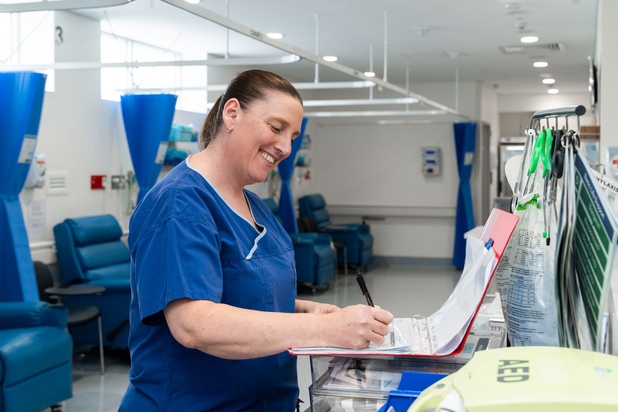 Patient standing at the reception desk with receptionist