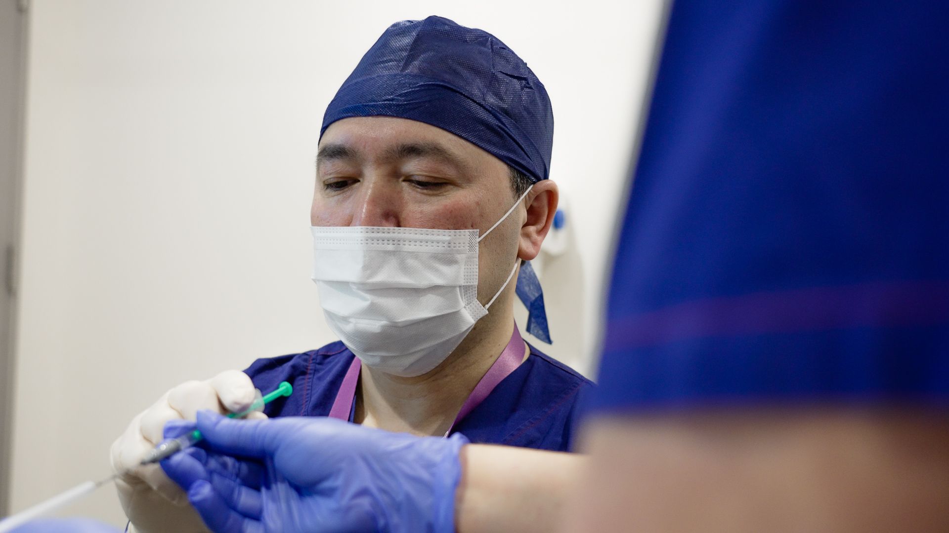 A fertility specialist prepares for an embryo transfer