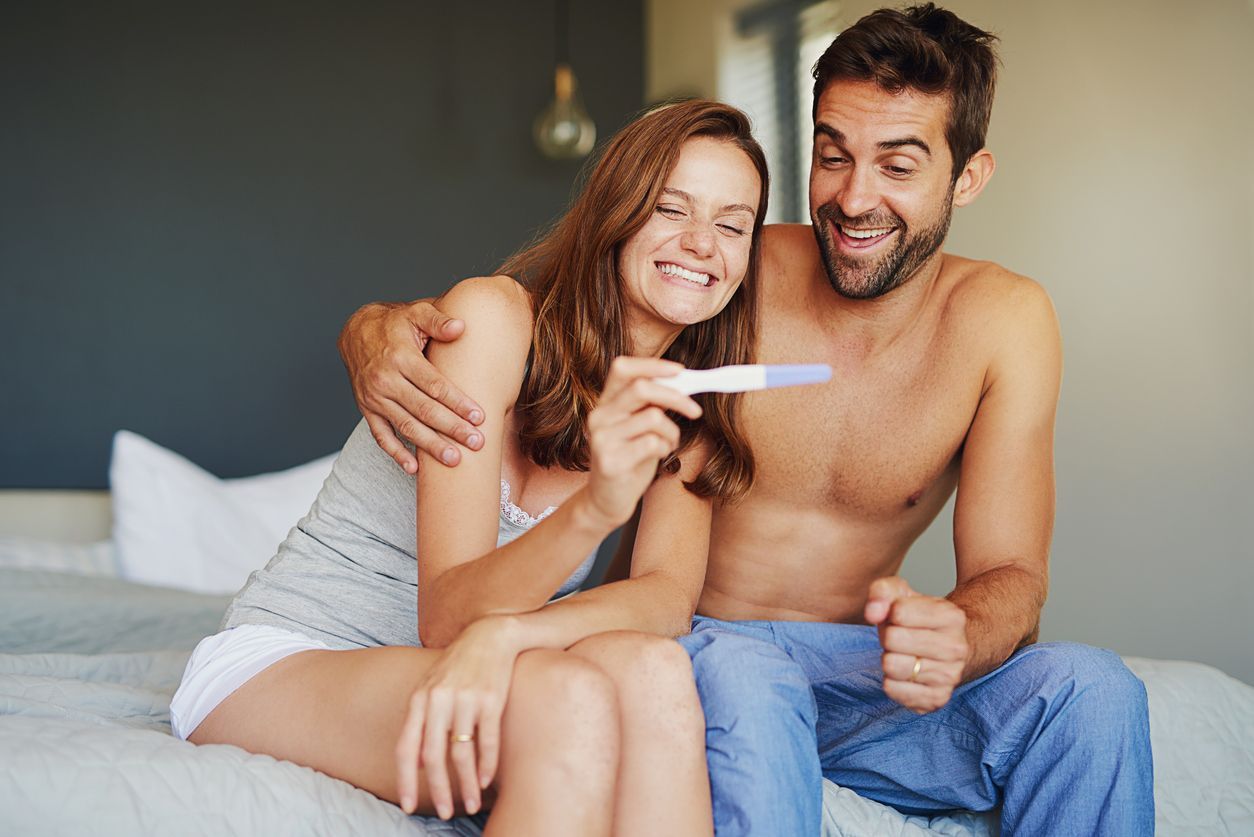 A couple taking a look at a pregnancy test