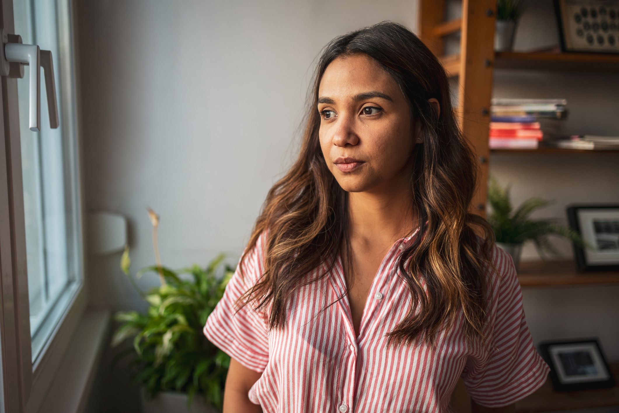 Woman looks out window