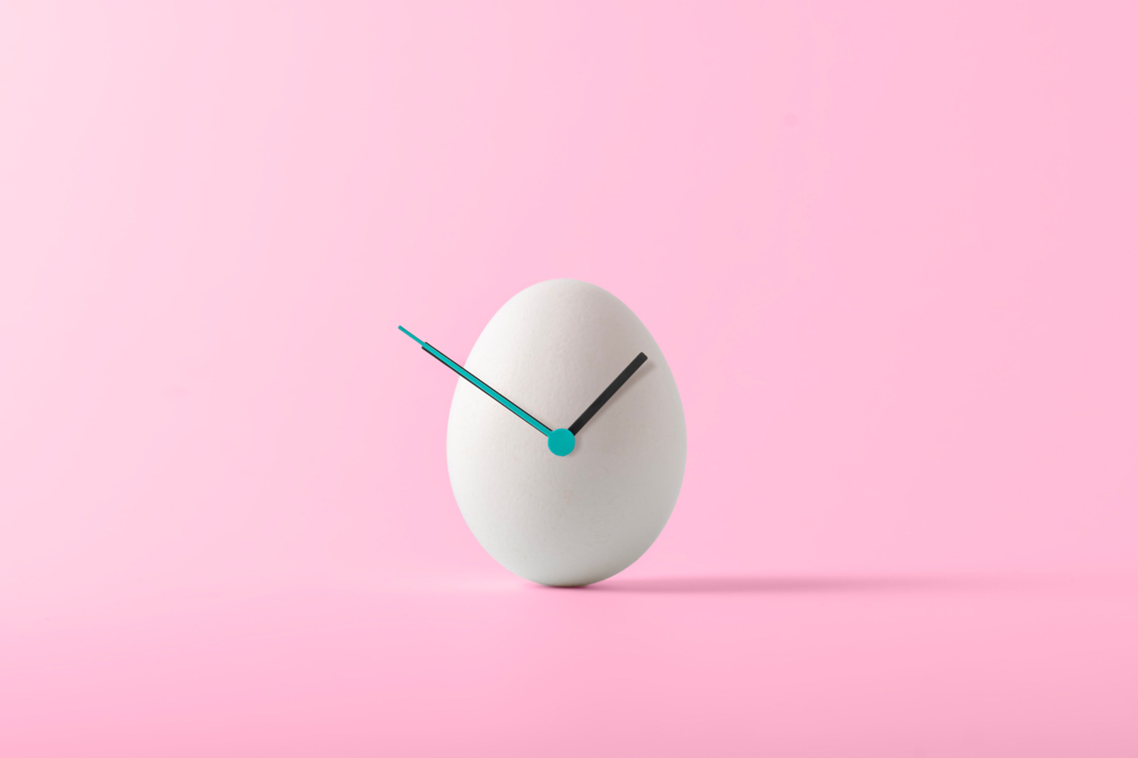 White egg with a clock overlaid.