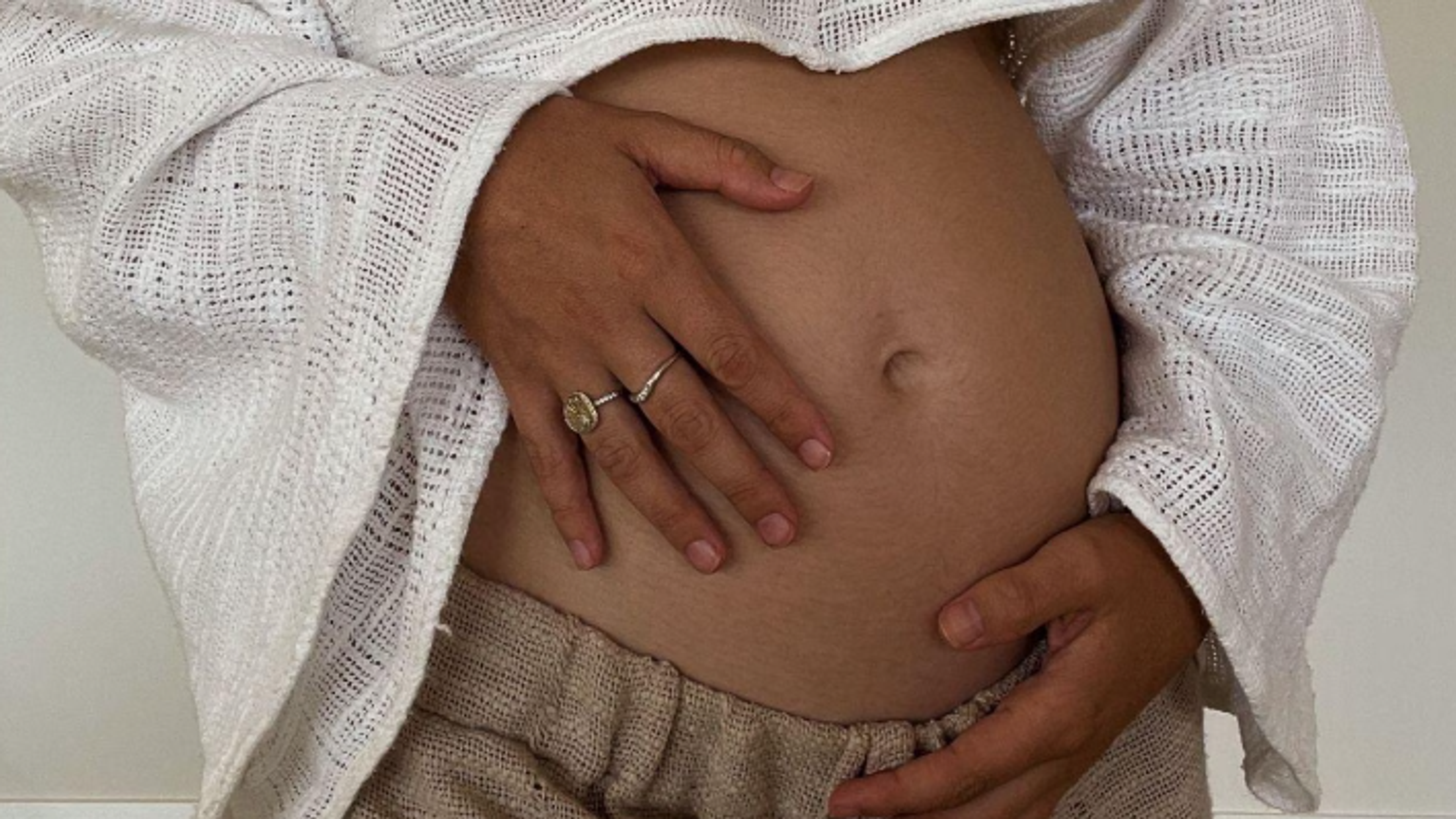 women holding pregnant belly
