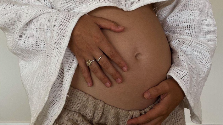 women holding pregnant belly