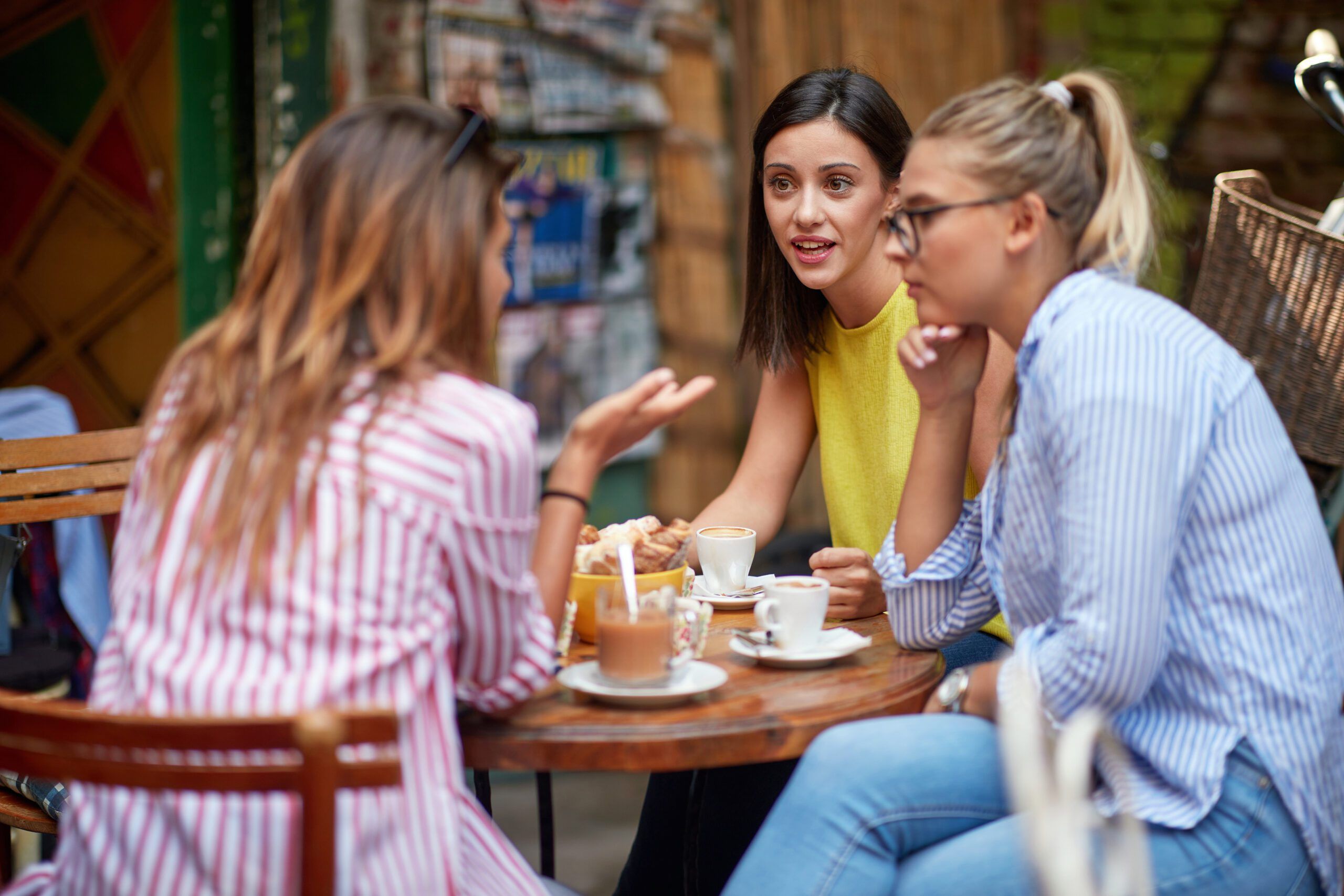 Three women discussing their lives