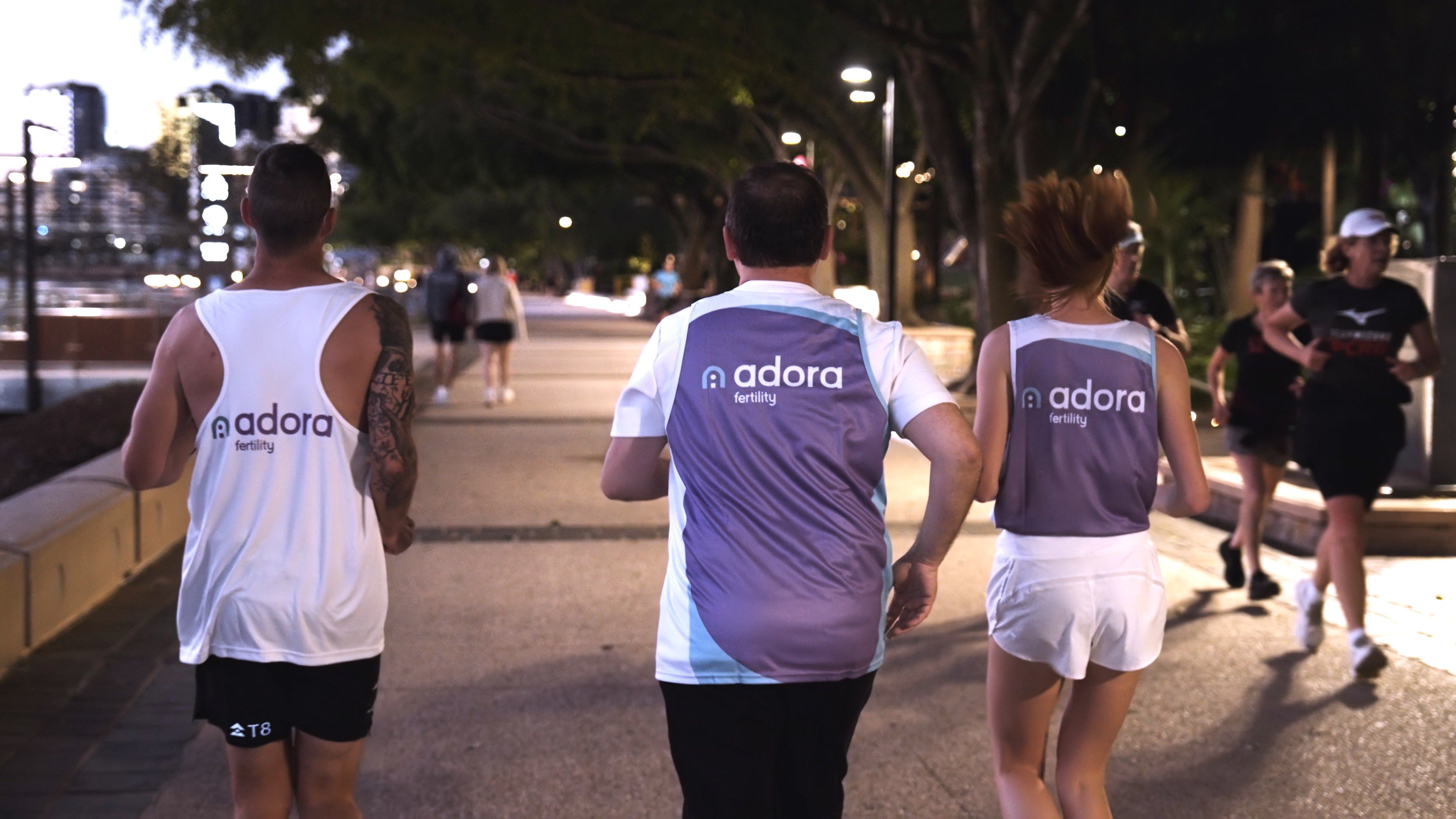 Group of people running in Adora singlets