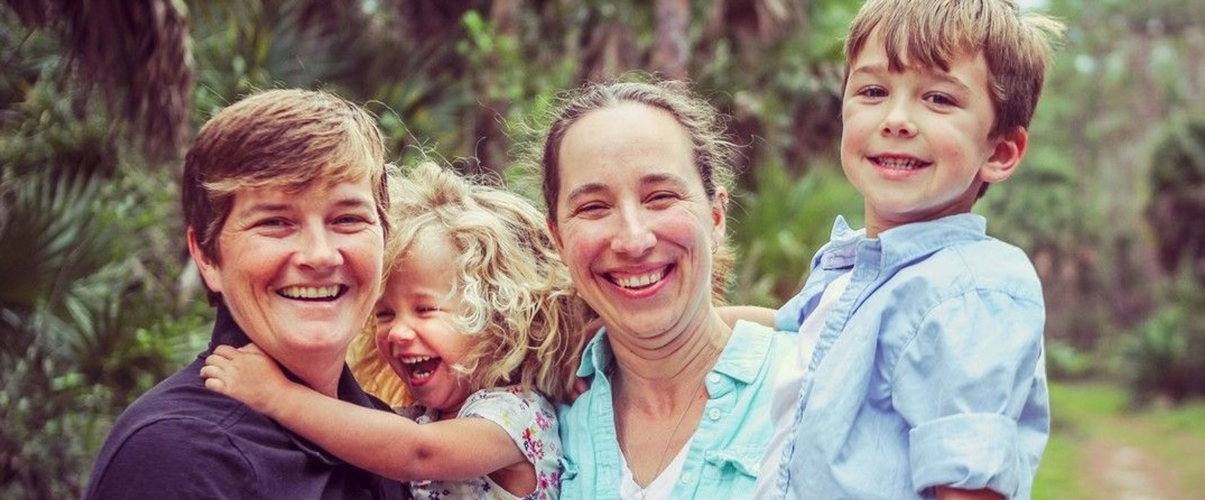 Smiling family with parents and 2 children
