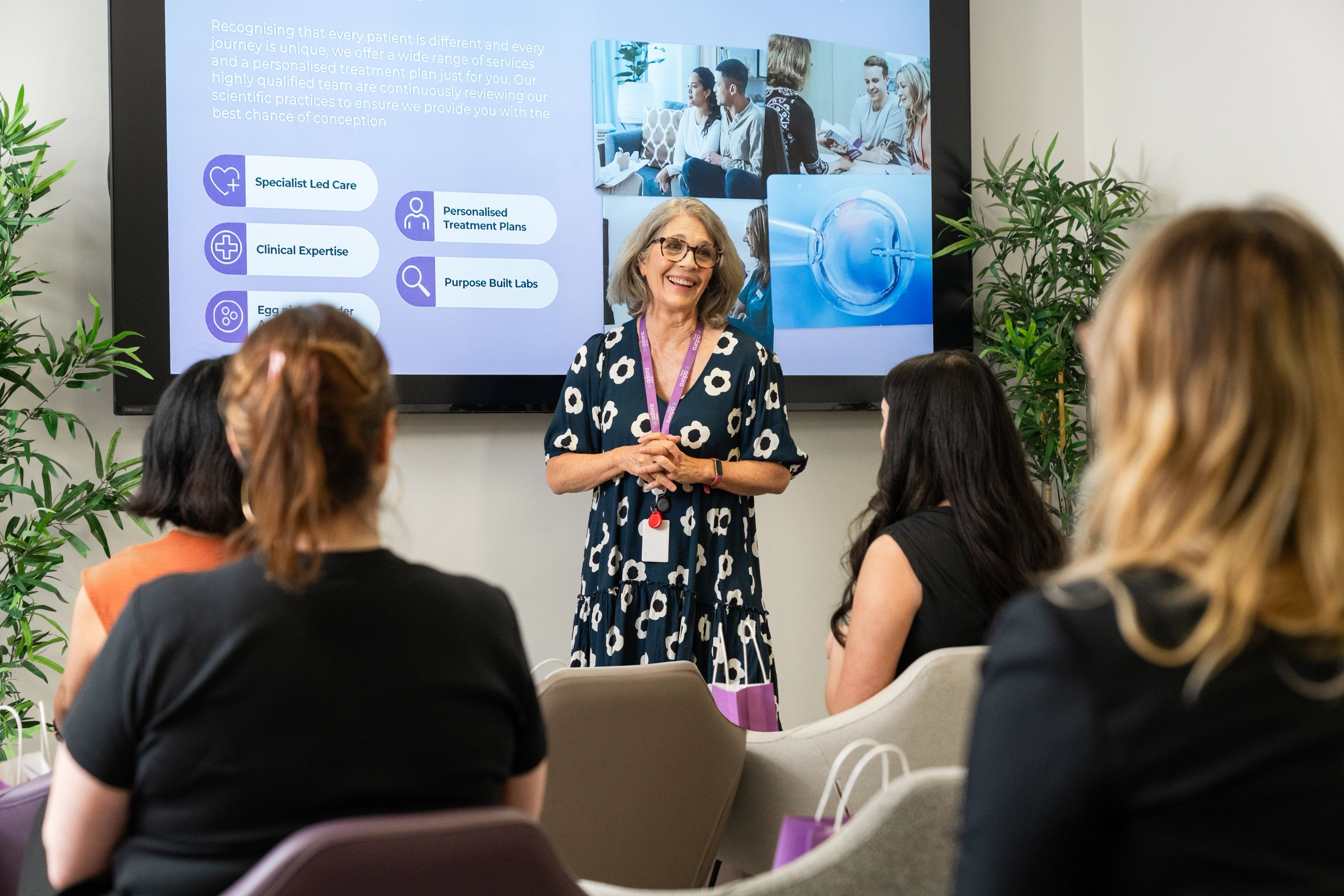 Woman holding a baby in her arms, smiling